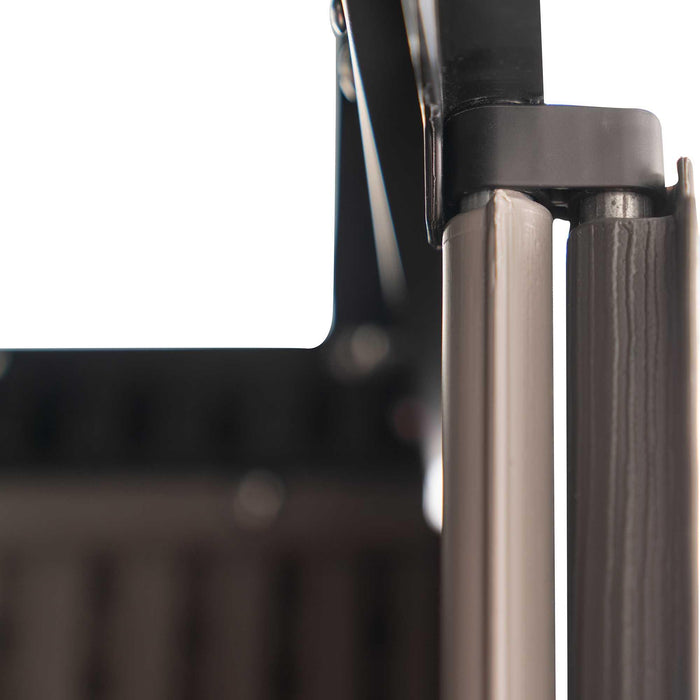 Extreme close-up of a steel door hinge pin and bracket joint on the Lifetime Farmhouse Shed 60542, showing durable metal construction against dark panel