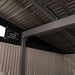 Interior ceiling view of the Lifetime Farmhouse Shed 60542 showing steel-reinforced roof beams, screened vent panel, and structured wall panel corner junction