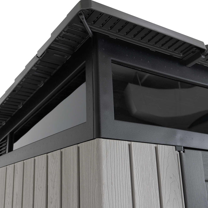Close-up of the Lifetime Farmhouse Shed 60542 roofline corner showing dark overhang, shatter-resistant skylight window frame, and wood-grain wall panels