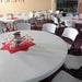 Lifetime 72 inch round commercial folding table set up for banquet event with white chairs, durable surface and steel frame support