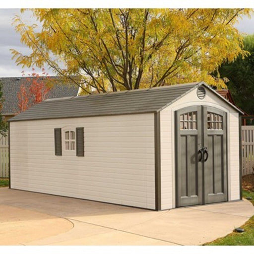 Lifetime 8x20 ft. storage shed installed on a driveway with autumn trees, front angle view with closed doors.