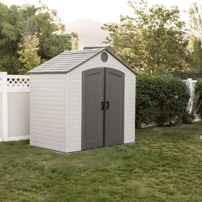 Lifetime 8x5 ft. outdoor storage shed shown from the front angle in a backyard, closed double doors.