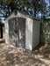 Lifetime 8x5 ft. storage shed installed on a shaded patio, front angle view with closed double doors.