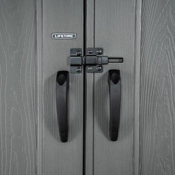 Close-up of the Lifetime-branded door handles and slider latch on the dual entry storage shed.