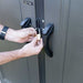 Close-up of a padlock securing the Lifetime-branded storage shed's door handles.