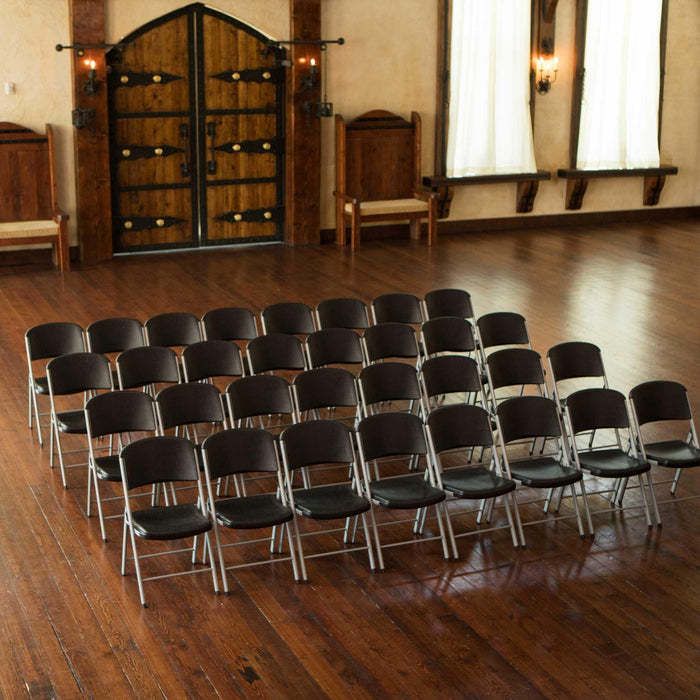 Rows of Lifetime Classic Commercial Folding Chairs arranged for an indoor event with wood flooring and rustic double doors in background