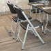 Lifetime Commercial Folding Chair in black with steel frame arranged at conference table for indoor meetings and training events