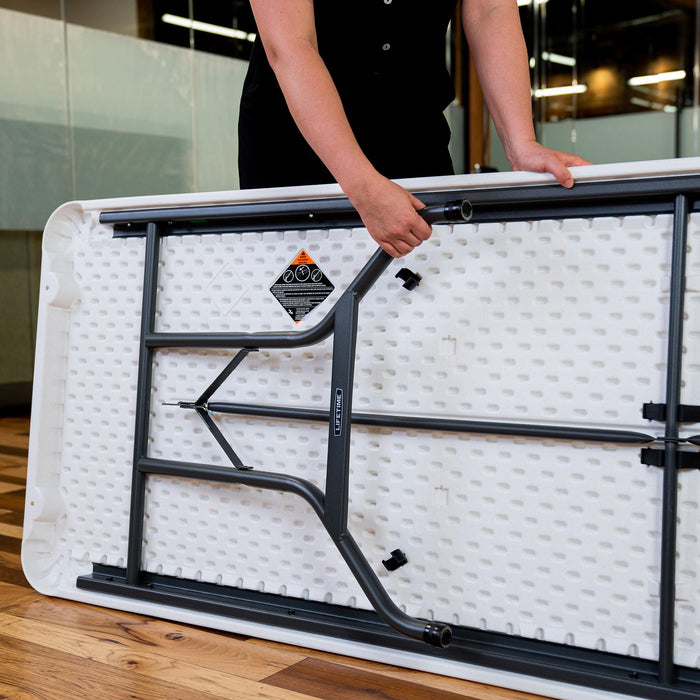 Close-up of Lifetime folding table underside showing reinforced steel frame, locking mechanism, and durable construction.