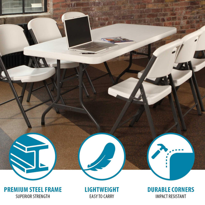 Lifetime folding table paired with white chairs in a meeting room, durable steel frame and spacious tabletop for work or dining