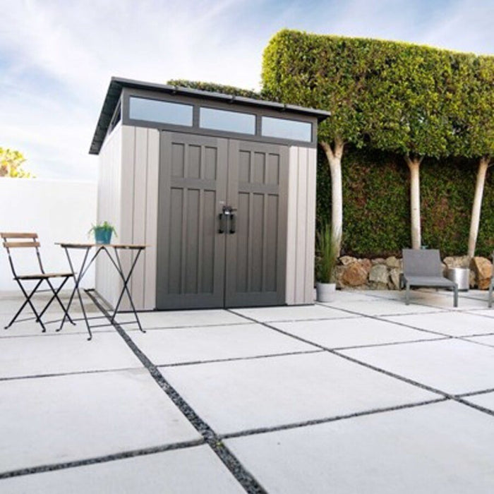 Lifetime Modern Shed installed on a patio with a hedge backdrop, front angle view with closed doors.