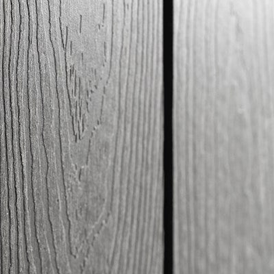 Close-up detail of the wood-grain texture on the exterior of a Lifetime 20x8 outdoor storage shed.