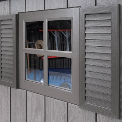 Close-up of a window on the Lifetime 20x8 outdoor storage shed, showing the gray frame, 4-pane window, and openable shutters.