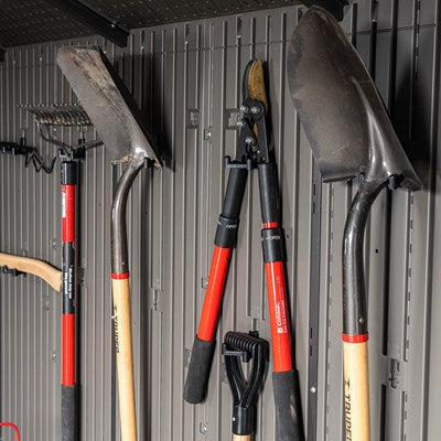 Gardening tools hanging neatly on the wall of a Lifetime 20x8 storage shed.