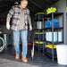 Man standing inside the Lifetime 8x15 ft. storage shed next to organized shelving and storage totes.