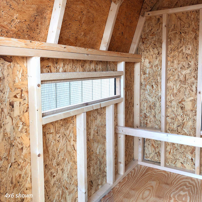Inside view of Little Cottage Co. 4x6 Gambrel Barn Coop with a front window, wooden frame, and natural lighting on the plywood floor.