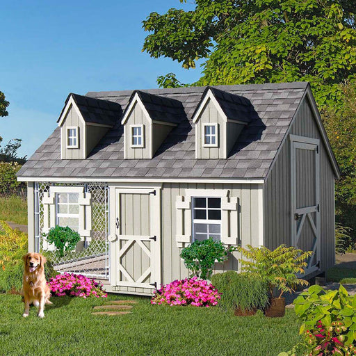 Little Cottage Co. Cape Cod Cozy Kennel featuring dormer windows, fenced run, and a dog sitting on the lawn in front.