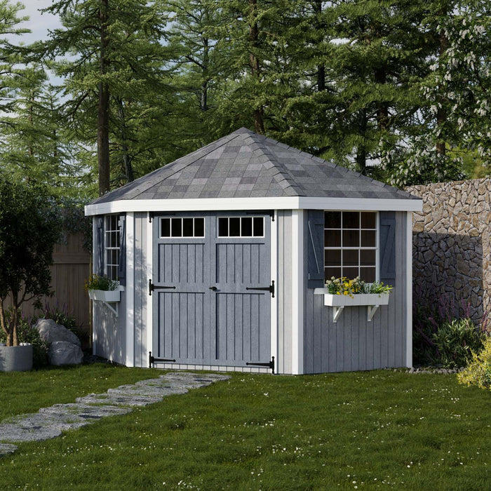 Blue and white Little Cottage Co. Colonial Five-Corner Shed with double doors, two windows, and flower boxes in a backyard setting.