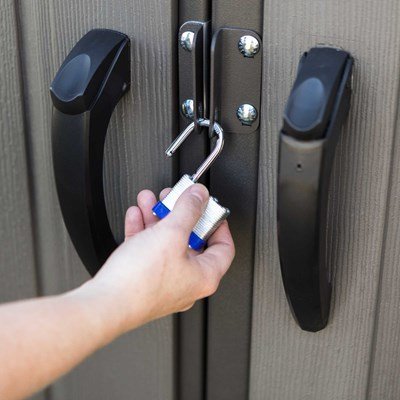 Close-up of a padlock securing the Lifetime 8x5 ft. storage shed's slider latch door handle.