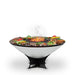 Arteflame 40" Platinum Series Fire Pit With Cooktop features a round cooking surface where you can arrange vegetables and meats around the perimeter, with flames centered in the middle The grill boasts a conical shape and is supported by a sleek black stand.