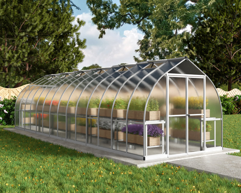 Exterior display of the Canopia Bella 8' x 28' Greenhouse showcasing lush plants inside