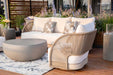 Elegant Malibu Collection sofa from Elementi Outdoor Furnitures featured on a wood deck with round coffee table and floral pillows