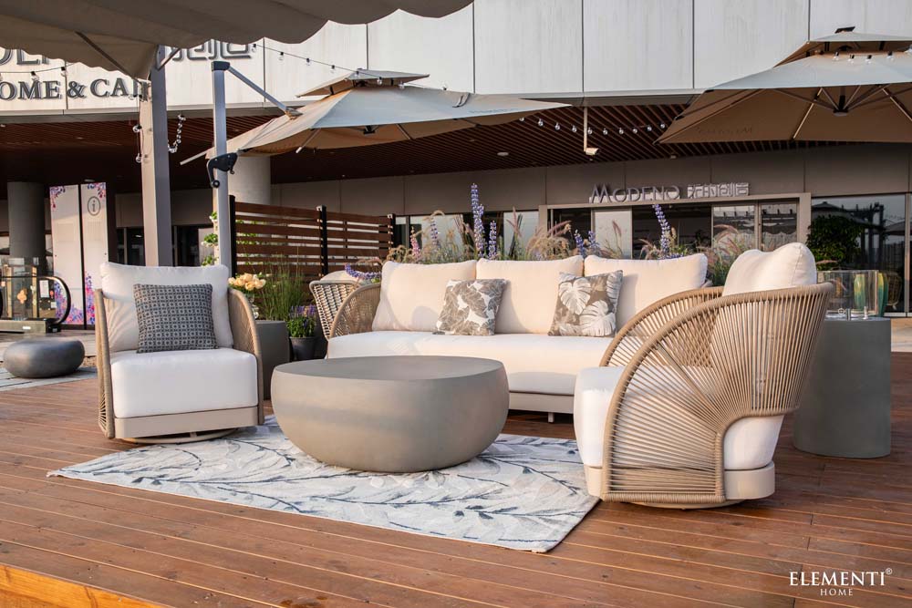 Elementi Outdoor Furnitures' Malibu Collection arranged on a wood deck with umbrellas, perfect for stylish lounging in a refined commercial space.