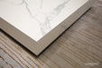 Close-up of the corner detail of the Elementi Marble Coffee Table, square large size in Bianco White, highlighting its sleek finish and marble veining.