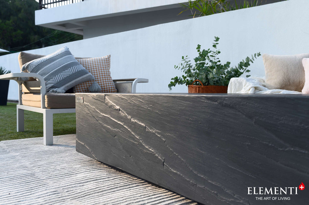  A sleek black textured marbled concrete Elementi Cape Town Fire Table on a patio, enhancing the outdoor ambiance