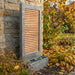 Modern copper slat wall fountain with rectangular basin, displayed in autumn garden with golden leaves and shrubs.