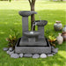 Modern Exaco Trio Bowl water fountain featuring three cascading basins on a square base surrounded by grass and decorative stones