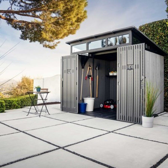 Lifetime Modern Shed with open doors on a hillside patio, table and chair nearby.