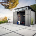 Lifetime Modern Shed with open doors on a hillside patio, table and chair nearby.