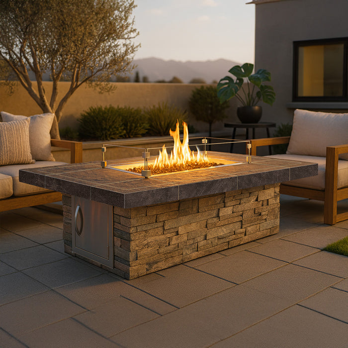 Cal Flame Mojave 72-inch rectangular fire pit shown in an outdoor patio setting with stacked stone base and active flame