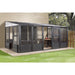 Sojag Charleston Solarium attached to a house, providing a spacious and bug-free outdoor living area