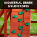 Close-up of the Nantucket II rock climbing wall with green plastic hand grips and industrial-grade nylon rope for safe backyard climbing