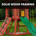 Close-up of solid wood framing on the Gorilla Playsets Nantucket II showing rock wall, green slide, sandbox, and tic-tac-toe panel