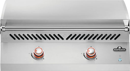 Front view of Napoleon Grills Built-In 700 Series 32" Griddle with lid open and blue-lit knobs