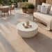 Elementi Plus Nimes fire pit table with closed lid used as a round coffee table, styled with coffee service on a sunlit patio