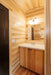 vanity area inside the Firestack Cabin bathroom with a mirror, sink, and cabinets