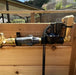 Installed Outdoor Living Today (OLT) Auto-Watering Kit showing connections on wooden surface.