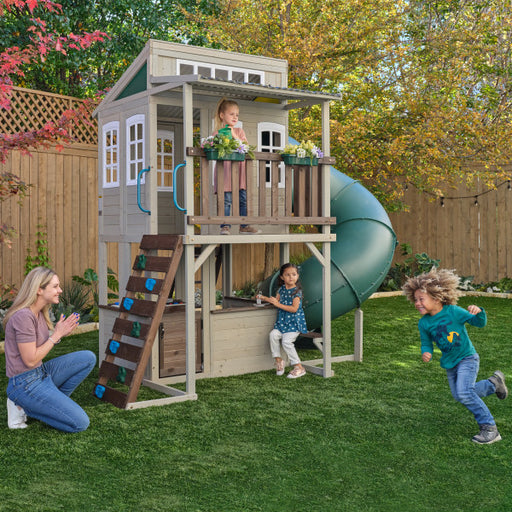A cozy playset placed on a backyard with kids