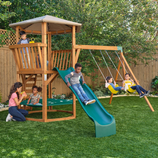 The Jungle journey swing set on a backyard with kids playing