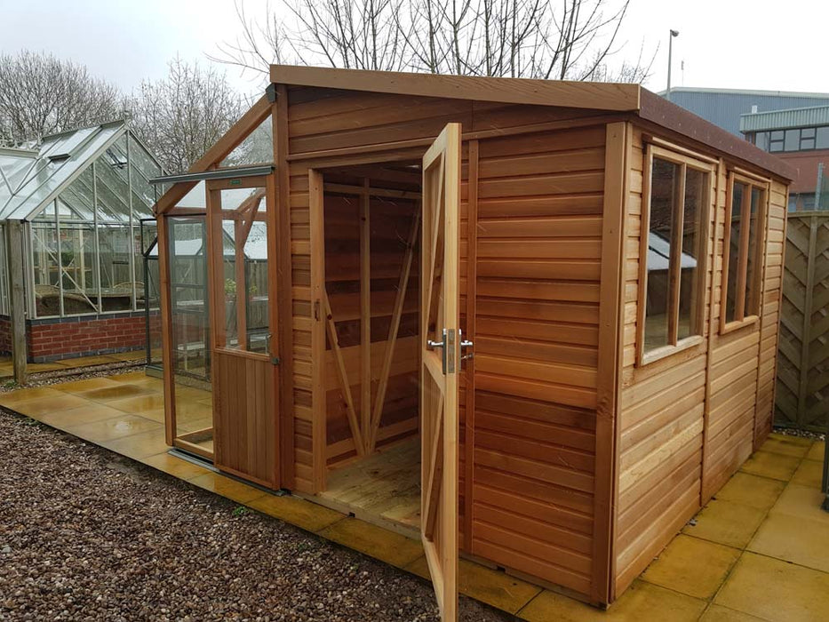 Side view of the Alton Cedar Fusion Greenhouse with an open door and visible wooden panels.