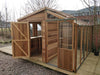 Exterior view of the Alton Cedar Fusion Greenhouse with all doors open, highlighting its wooden and glass structure.