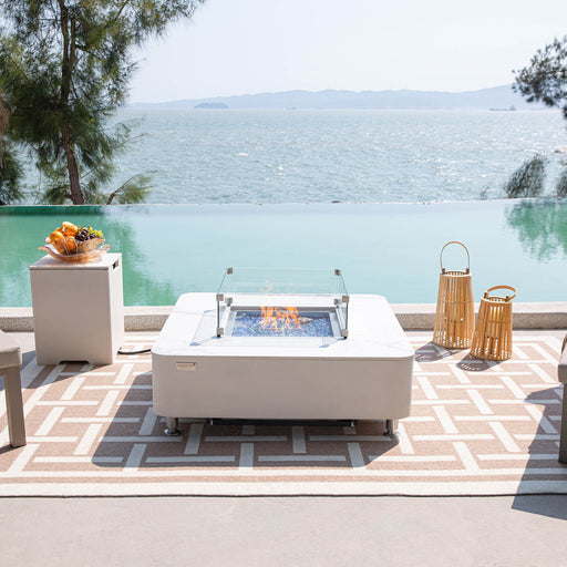 Elementi Plus Porcelain Fire Table outdoor beside a pool