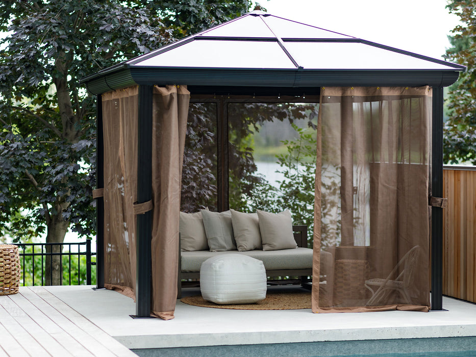 Open 10x10 Venus Metal Gazebo with sheer nettings and privacy curtains partially drawn, revealing a cozy interior with cushioned seats on a deck by a pool.