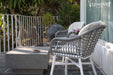 A close-up view of the Elementi Tevere Series Rectangle Medium Coffee Table in Space Grey on a stylish outdoor patio.