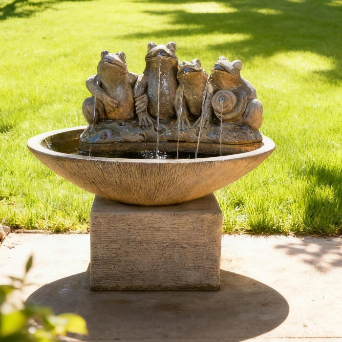 Outdoor four frog bowl fountain garden accent with textured pedestal base and tranquil water flow on lawn