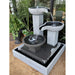 An outdoor garden scene showcasing the Exaco Trio Bowl Fountain. 