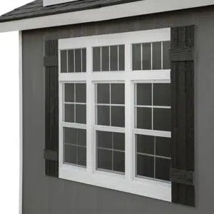 Handy Home Windmere shed showcasing a stylish window set with three large windows framed by decorative shutters, ideal for natural light in your backyard storage or workspace solution. 